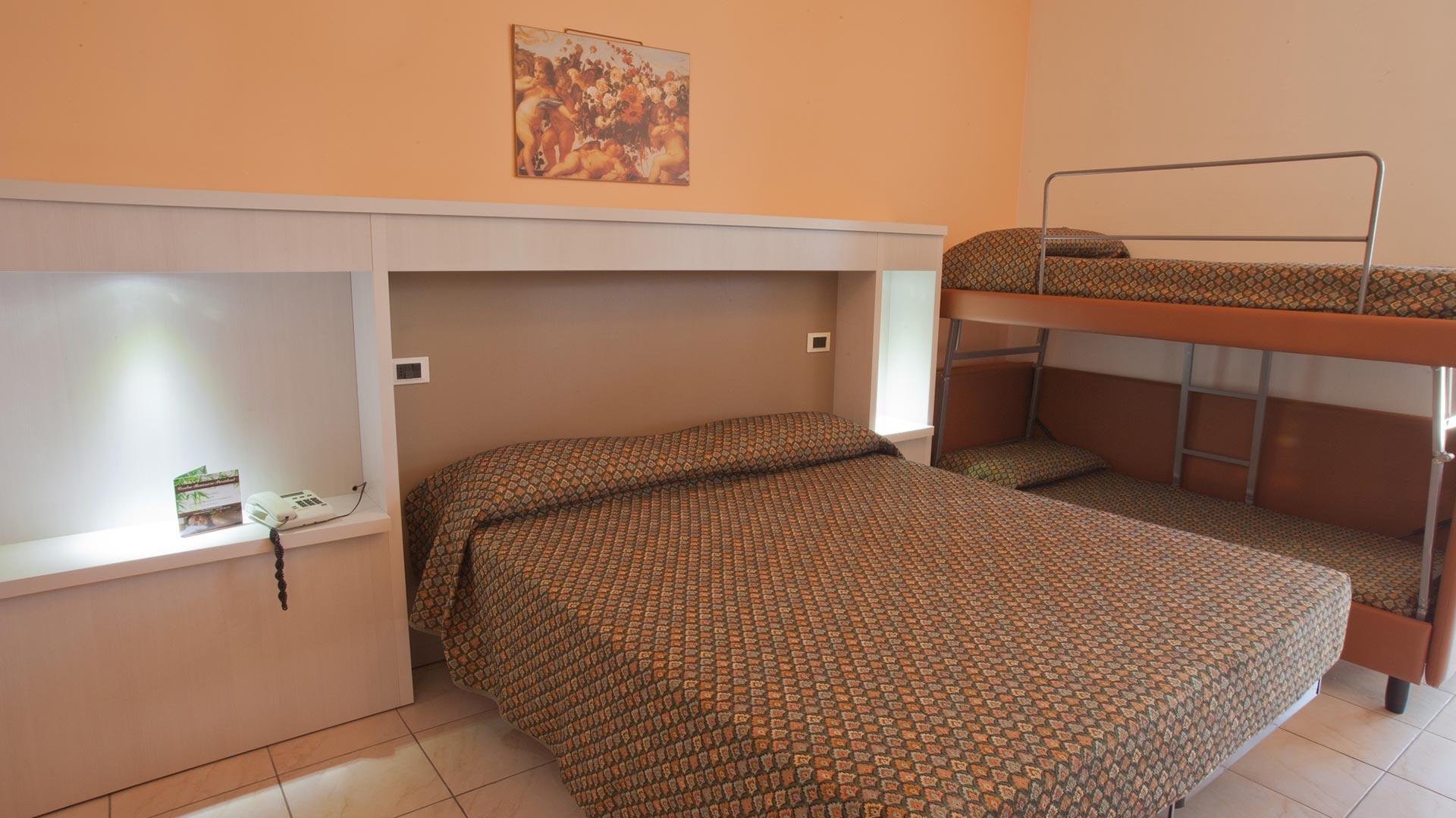 Room with a double bed and bunk bed, decorated with a painting.